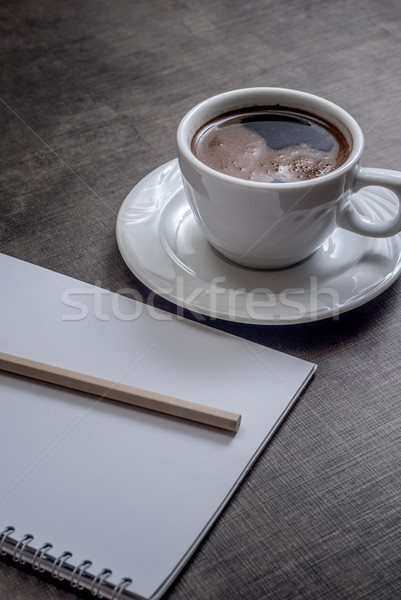 Stock photo: A blank white notebook and cup of coffee 