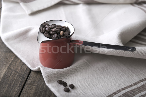 Coffee beans in an enamel mug. Stock photo © nessokv