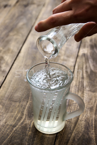 woman pouring water into a glass Stock photo © nessokv