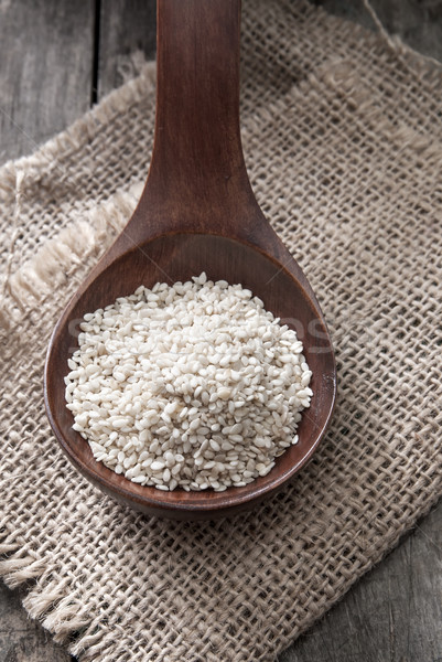 Organic natural sesame seeds on wooden spoon Stock photo © nessokv