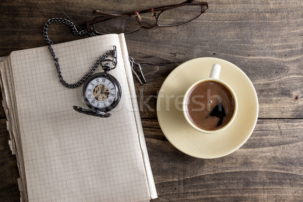 Vintage pocket watch with cup of coffee on old book Stock photo © nessokv