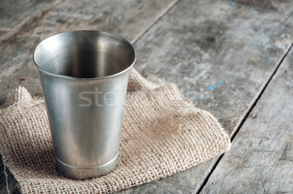 old metal cup on wooden table Stock photo © nessokv