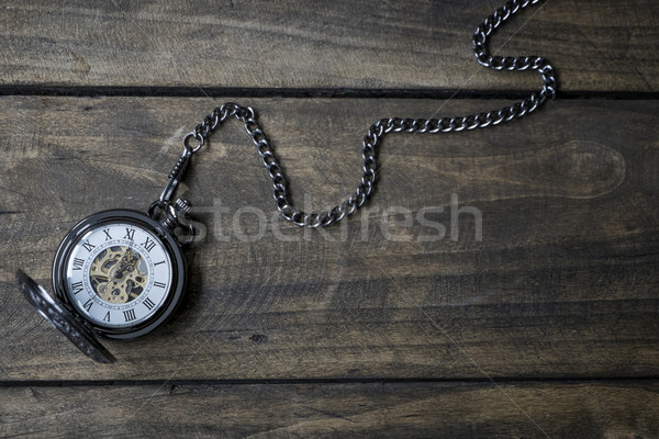  Vintage watch on a wooden background showing five to twelve. Stock photo © nessokv