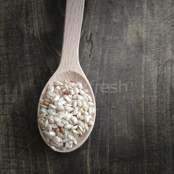 Brown rice in wooden spoon  Stock photo © nessokv