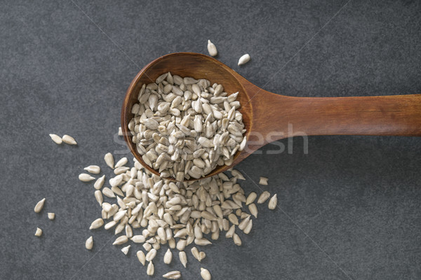 Sunflower seed with a wooden spoon. Stock photo © nessokv