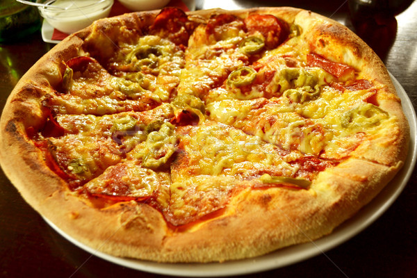 whole italian pizza on wood table with ingredients  Stock photo © nezezon