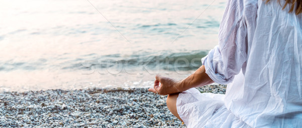 Woman meditating at the sea Stock photo © Nickolya
