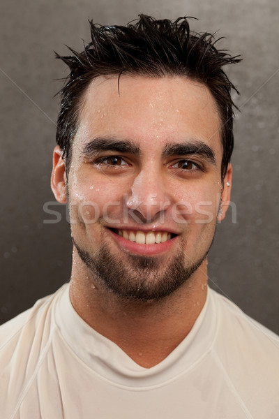 Headshot on a young man. Wet look with grey background. Stock photo © nickp37