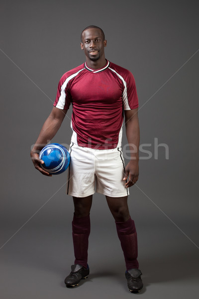 Male soccer player. Studio shot over grey. Stock photo © nickp37