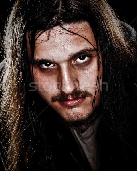 Young man with long hair. Studio shot over black. Stock photo © nickp37