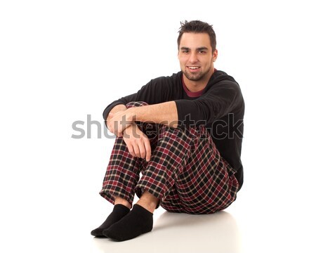 Attractive man in pajamas. Studio shot over white. Stock photo © nickp37