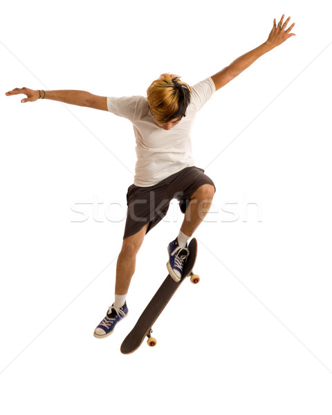 Young man skateboarding. Studio shot over white. Stock photo © nickp37