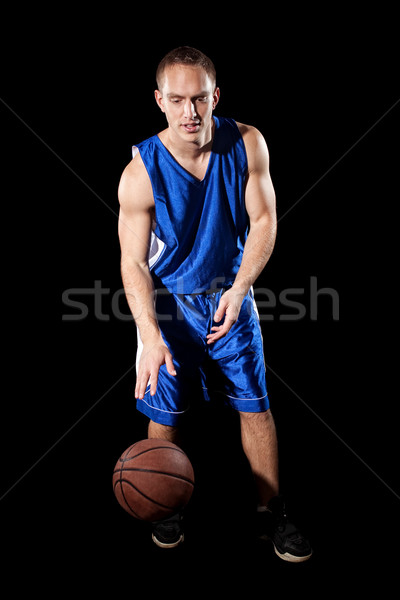 Male basketball player. Studio shot over black. Stock photo © nickp37