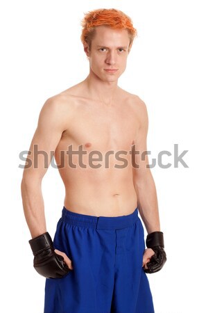 Stock photo: Martial artist in blue shorts. Studio shot over white.