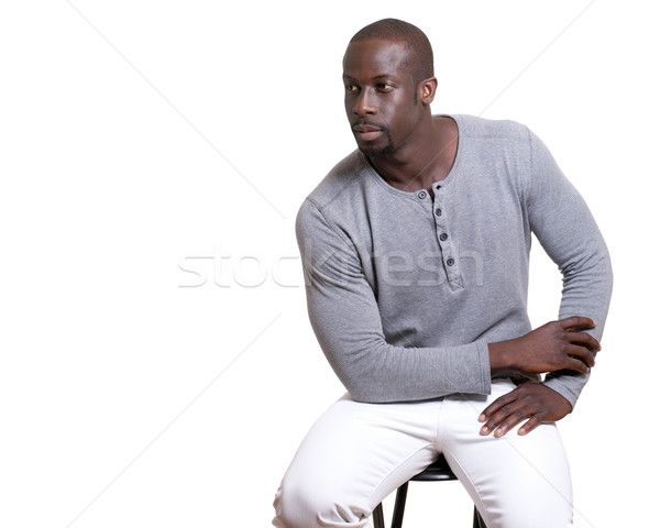 Man in grey shirt and white pants. Studio shot over white. Stock photo © nickp37