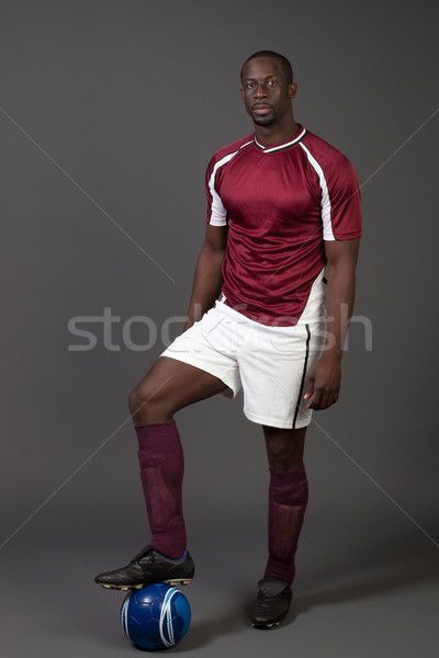 Male soccer player. Studio shot over grey. Stock photo © nickp37