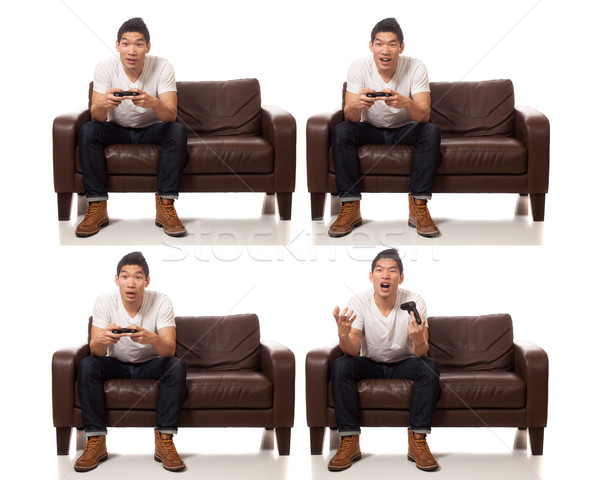Young man playing video games. Studio shot over white. Stock photo © nickp37
