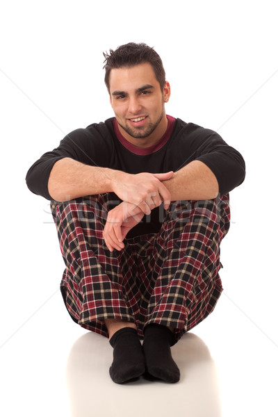 Stock photo: Attractive man in pajamas. Studio shot over white.