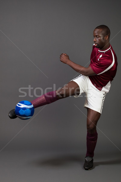 Male soccer player. Studio shot over grey. Stock photo © nickp37