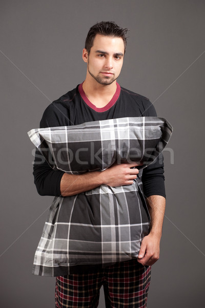 Attractive man in pajamas. Studio shot over grey. Stock photo © nickp37