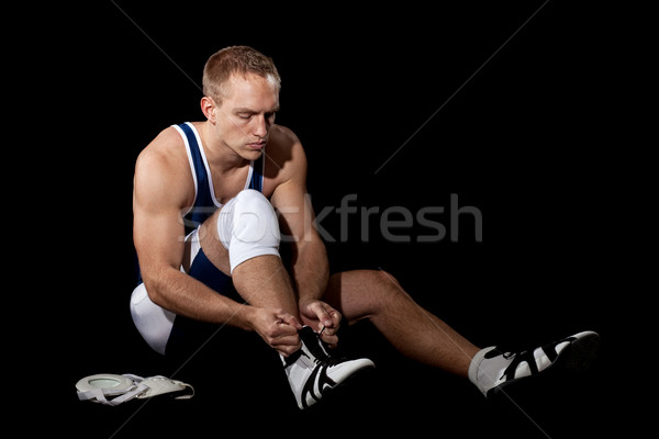 Wrestler in a blue singlet. Studio shot over black. Stock photo © nickp37