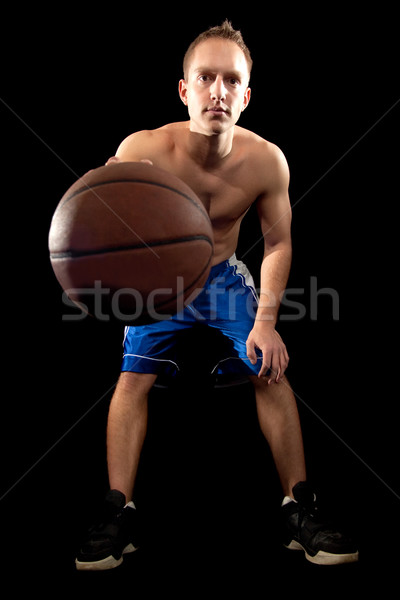 Male basketball player. Studio shot over black. Stock photo © nickp37