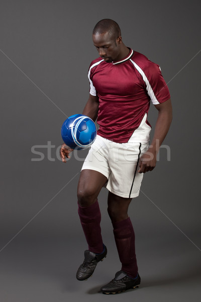 Male soccer player. Studio shot over grey. Stock photo © nickp37