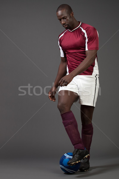 Male soccer player. Studio shot over grey. Stock photo © nickp37