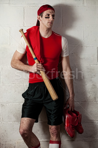 Baseball player in front of concrete block wall. Stock photo © nickp37