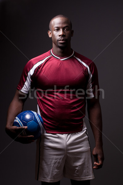 Male soccer player. Studio shot over grey. Stock photo © nickp37