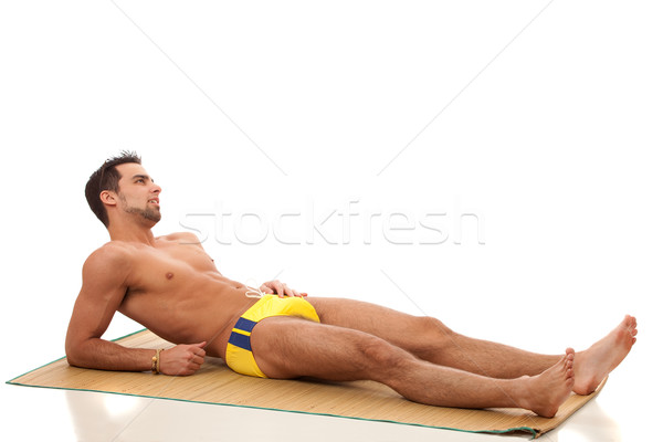 Attractive young man in swimsuit. Studio shot over white. Stock photo © nickp37