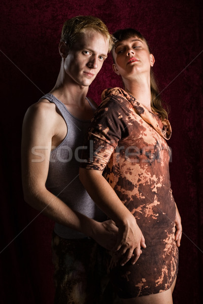 Alt fashion couple. Moody studio shot over dark red. Stock photo © nickp37