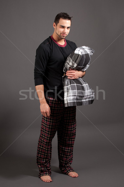 Attractive man in pajamas. Studio shot over grey. Stock photo © nickp37