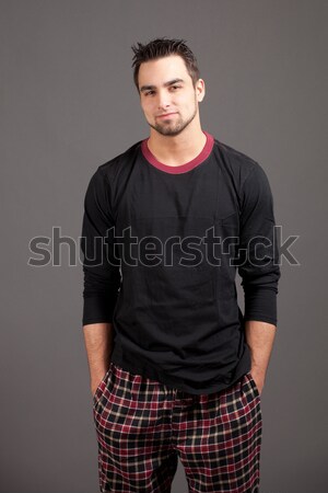 Attractive man in pajamas. Studio shot over grey. Stock photo © nickp37