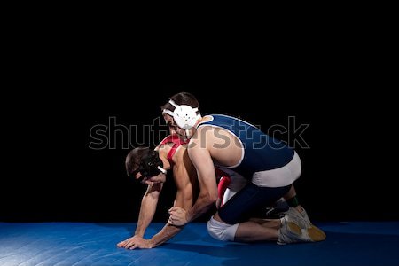 Wrestling acţiune negru sportiv albastru Imagine de stoc © nickp37