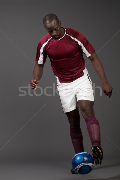 Male soccer player. Studio shot over grey. Stock photo © nickp37