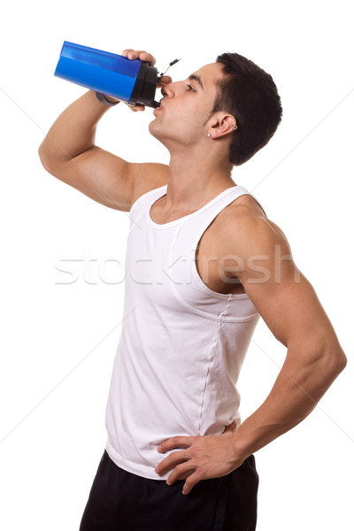 Stock photo: Athletic man with water bottle. Studio shot over white.