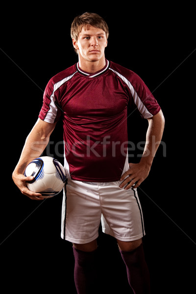 Male soccer player. Studio shot over black. Stock photo © nickp37