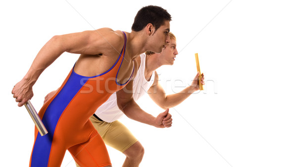 Track and field athletes competing in a relay race. Studio shot over white. Stock photo © nickp37