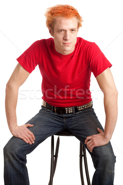 Young man in a red shirt and jeans. Studio shot over white. Stock photo © nickp37