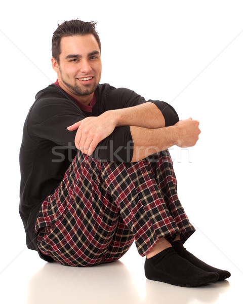 Attractive man in pajamas. Studio shot over white. Stock photo © nickp37