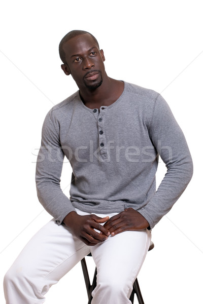 Man in grey shirt and white pants. Studio shot over white. Stock photo © nickp37