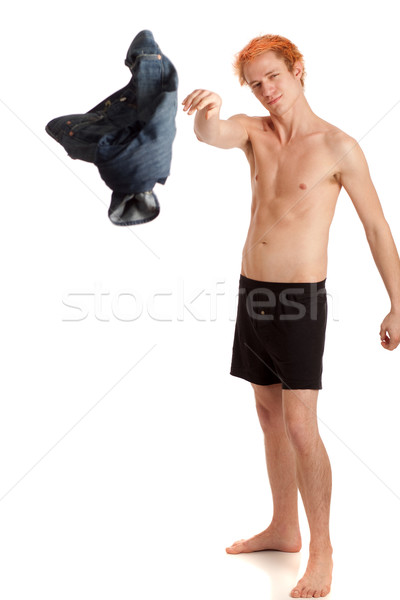 Man in boxers throwing jeans. Studio shot over white. Stock photo © nickp37