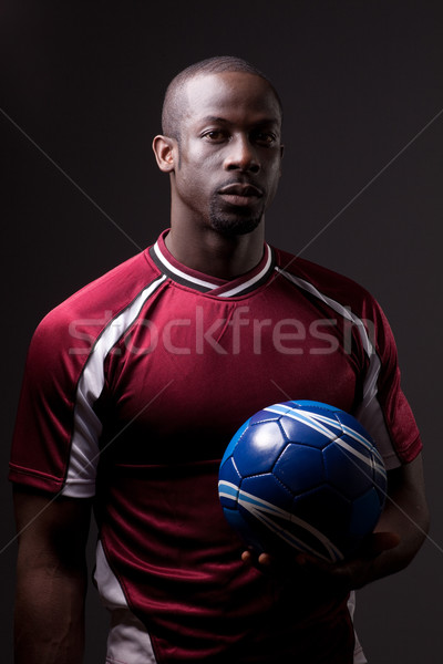 Male soccer player. Studio shot over grey. Stock photo © nickp37