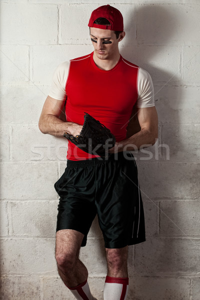 Baseball player in front of concrete block wall. Stock photo © nickp37