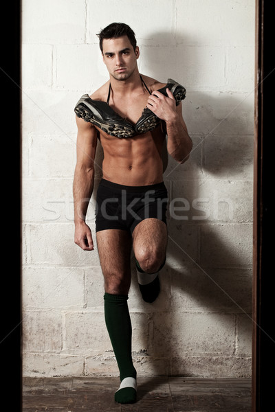 Male rugby player in front of concrete block wall. Stock photo © nickp37