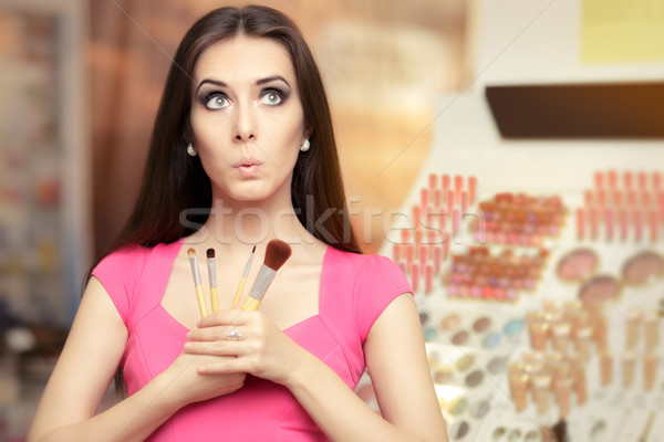 Surprised Girl Holding a Make-up Brush Stock photo © NicoletaIonescu
