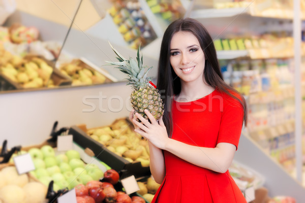 Happy Woman with Pineapple Fruit in Supermarket Stock photo © NicoletaIonescu