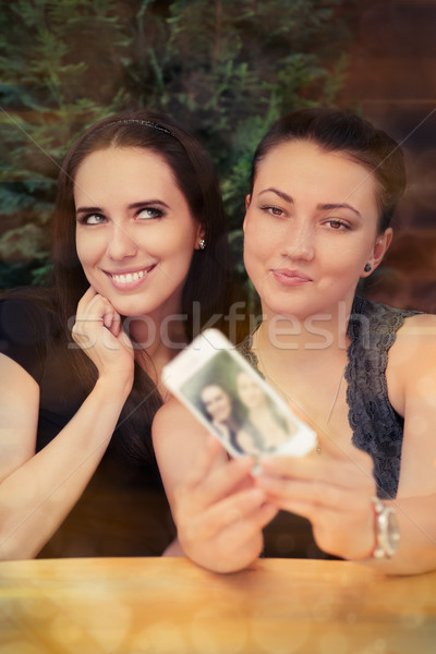 Young Women Taking a Funny Selfie Together  Stock photo © NicoletaIonescu