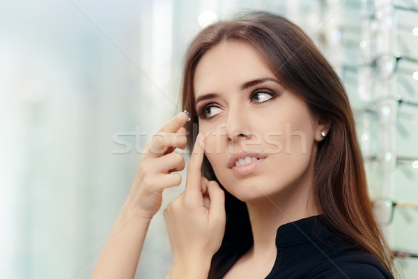 Woman with Cosmetic Colored Lenses in Optical Store Stock photo © NicoletaIonescu